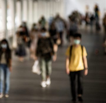 Crowd of people wearing mask walking in the new normal