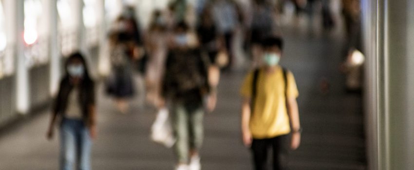 Crowd of people wearing mask walking in the new normal